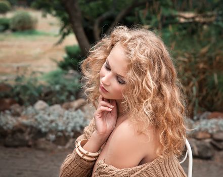 young beautiful woman is resting in the garden