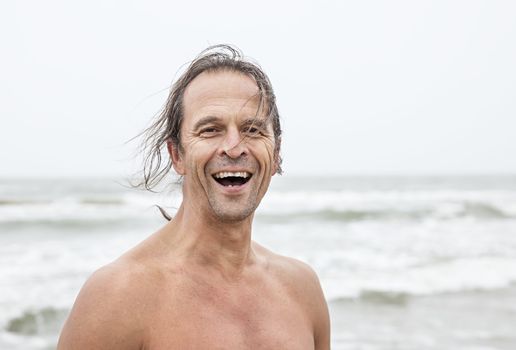 Portrait of a middle-aged man smiling on the beach