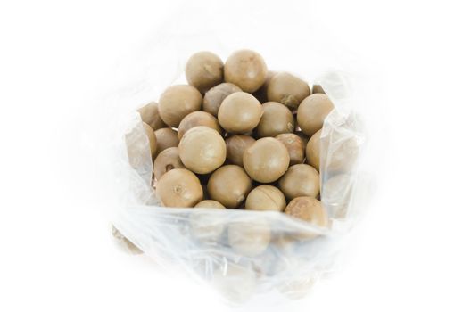 top view  macadamia in plastic bag on white background