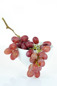 grape fruits  in white bowl on white background