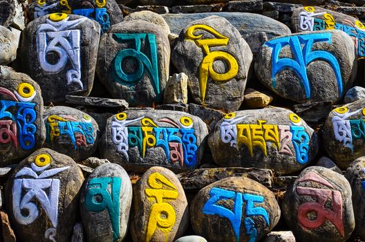 Tibetan religious budhist symbols carved on stones, Nepal