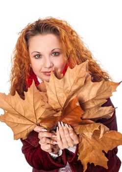 Redhead girl with dry autumn leaves