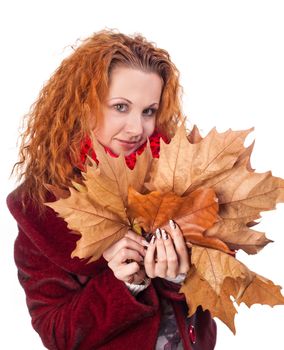 Redhead girl with yellow autumn leaves