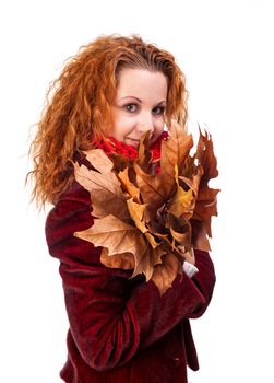 Redhead girl with dry autumn leaves