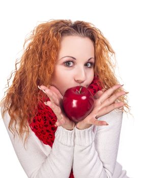 Red-haired girl with apple isolated on white