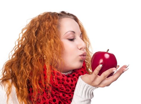 Red-haired girl with apple isolated on white