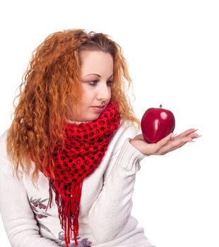 Red-haired girl with apple isolated on white