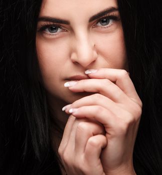Pretty young brunette looking thoughtfully