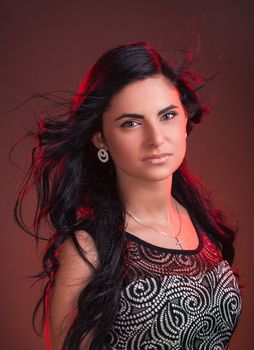 Portrait of a beautiful young woman with hair flying