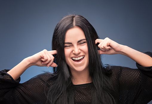 pretty girl closing her ears with fingers 