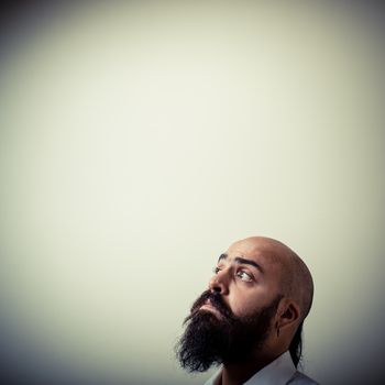 long beard and mustache man with white shirt on gray background