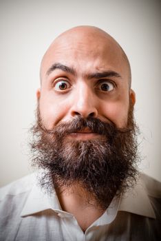 funny long beard and mustache man with white shirt on gray background