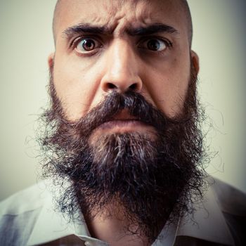 funny long beard and mustache man with white shirt on gray background