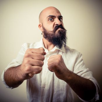 angry fighter long beard and mustache man  on gray background