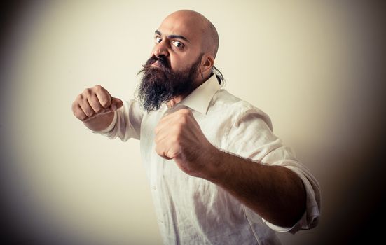 angry fighter long beard and mustache man  on gray background
