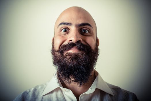 long beard and mustache man with white shirt on gray background