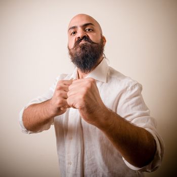 angry fighter long beard and mustache man  on gray background