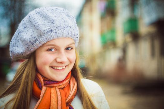 Teen Girl Wearing White Beret And Orange Scarf In Windy Day