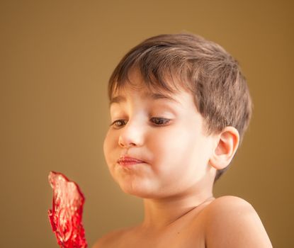 Close Up of Young Boy Eating A Lollipop