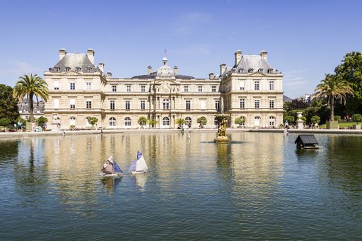 Traditional small wooden sailing boat in the pond of park Jardin du Luxembourg, Paris, France