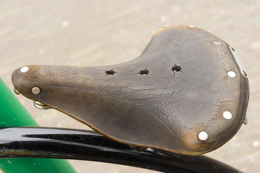 vintage leather bike saddle with metal rivets