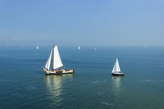 Seascape with big and small sailboats 