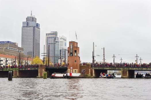 AMSTERDAM, THE NETHERLANDS - NOVEMBER, 18, 2012 - People waiting for Sinterklaas on the Berlagebrug through Amstel river. Santa Claus(Sinterklaas) traditionally arriving in Holland by steamboat from Spain in November.