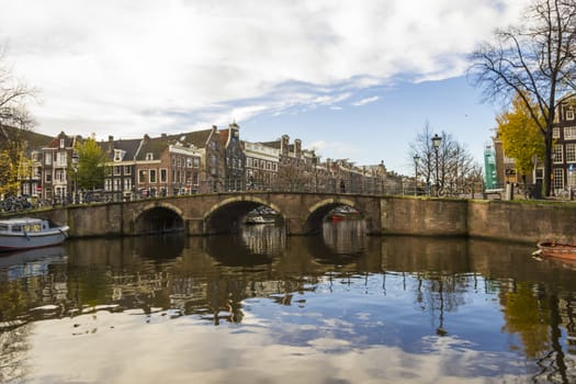 View on a canal bridge in Amsterdam in late autumn