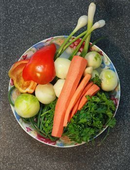 vegetables on plate for preparation of dish, in kitchen