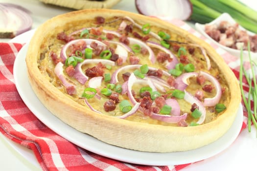 freshly baked onion tart with ham cubes