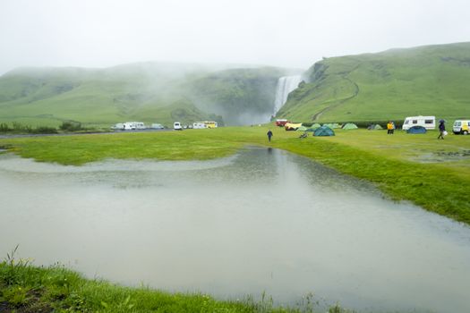 tent camp near Skogarfoss waterfall in Iceland, summer