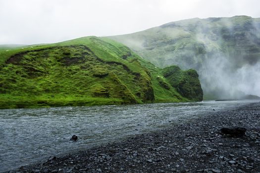 Skoga river near Skogafoss waterfall in Iceland, rainy summer