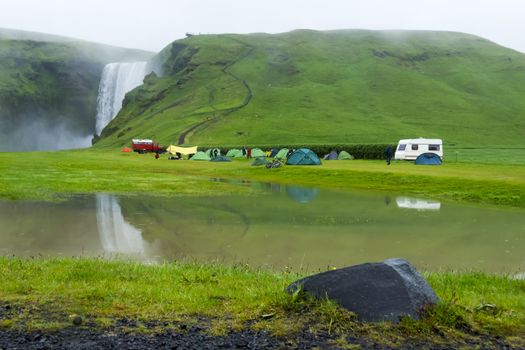 tent camp near Skogarfoss waterfall in Iceland, summer