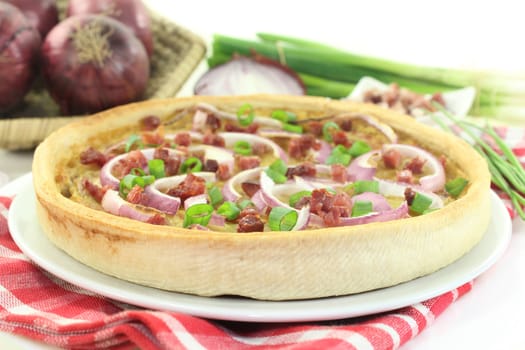 freshly baked onion tart with ham cubes