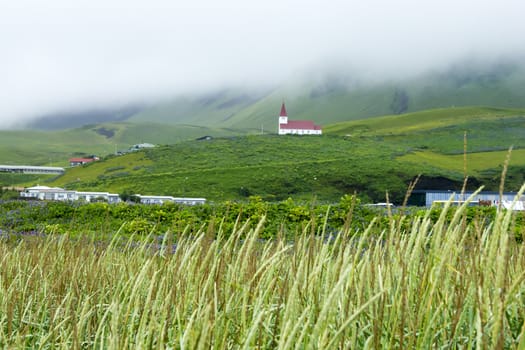 Fog over the village, Iceland, summer