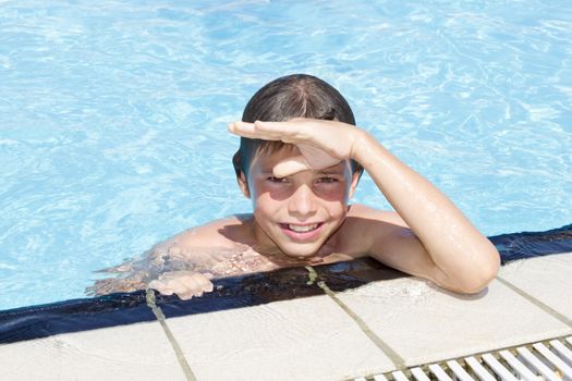 Activities on the pool. Cute boy swimming and playing in water in swimming pool