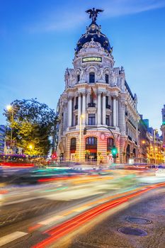 Rays of traffic lights on Gran via street, main shopping street in Madrid at night. Spain, Europe.