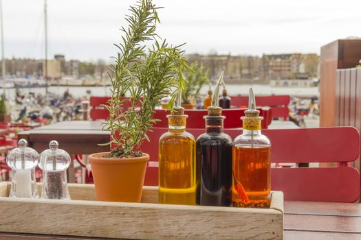balsamic vinegar bottles and condiments on the table in an open cafe