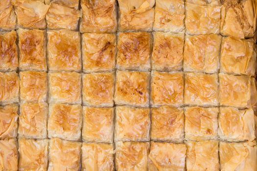 Fourty pieces of baklava just came out from the owen and waiting to be consumed, shot from above, baklava background