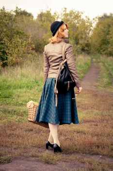 Portrait of a beautiful redhair girl in the autumn park. Caucasian race.