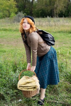 Portrait of a beautiful redhair girl in the autumn park. Caucasian race.