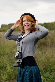 Portrait of a beautiful redhair girl in the autumn park. Caucasian race.