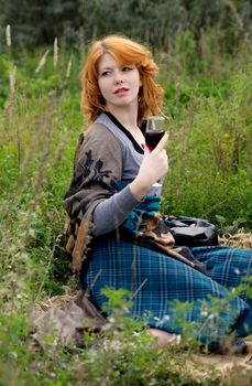 Portrait of a beautiful redhair girl in the autumn park. Caucasian race.