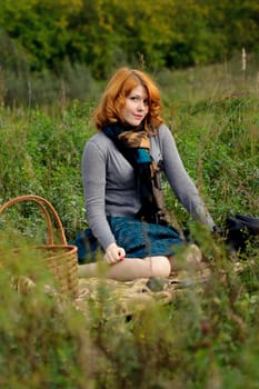 Portrait of a beautiful redhair girl in the autumn park. Caucasian race.