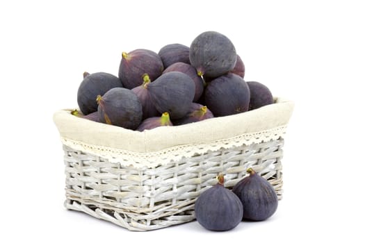 fresh figs in a basket on white background
