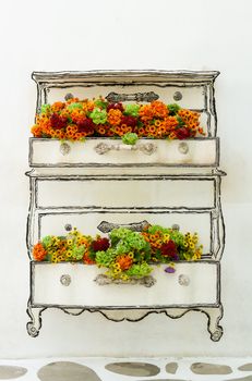Artificial flowers decoration on concrete wall