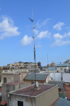 Transmission mast on a roof top in a Spanish City.