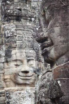 Faces carved in stone in  Bayon temple   in Angkor Thom Cambodia. Bayon temple was built late 12th century under king  Jayavarman VII