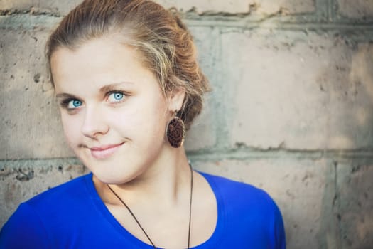 Young Blue-Eyed Girl Near Brick Wall