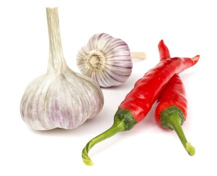 Pepper and garlic lie on white background 